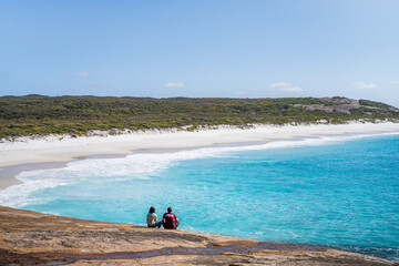 Wall Mural - Couple looking over an empty beach in the Cape Arid National Park. 