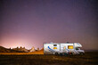Camper rests by RV and illuminated tufa spires