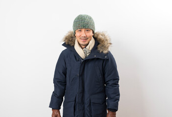 Handsome asian man dressed with winter clothing, hat and scarf isolated on white background