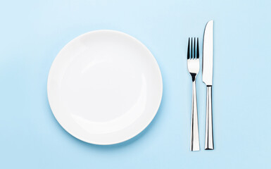 Empty plate, fork and knife