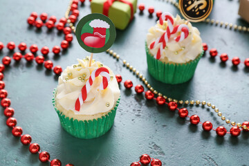 Wall Mural - Composition with tasty Christmas cupcakes on table