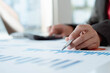 © PaeGAG - Business people are analyzing and evaluating marketing for a company using graphs on their desks in the office Concept of business risk analysis and assessment