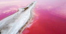 The Shore Of The Island On The Pink Lake Is Covered With Salt.