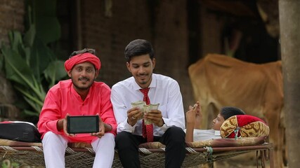 Wall Mural - indian farmer and agronomist or banker showing smartphone at home