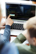 © Comeback Images - Over the shoulder view of two unrecognizable school kids learning how to code on laptop computer, one boy pointing at menu on screen