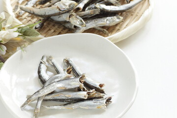 Wall Mural - Japanese food ingredient,  dried small sardines on bamboo basket for broth cooking