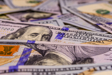 Wall Mural - Background of one hundred dollar banknotes. Selective focus