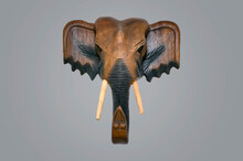 Wooden Souvenir From Travel. Travel Concept. Wooden Elephant Mask On Gray Background.