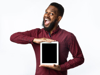 Excited African Man Showing Tablet Blank Screen Over White Background