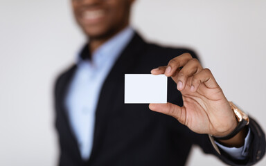 Empty card in african american man hands, selective focus