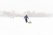 © Елена Гурова - dad is driving his daughter on a sled in a severe blizzard