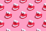 Fototapeta  - Pattern plastic toy in the form of red jaws with white teeth and eyes