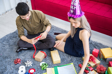 Wall Mural - young couple preparing christmas gift box presents for Christmas and new years party