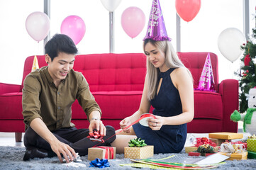 Wall Mural - young couple preparing christmas gift box presents for Christmas and new years party