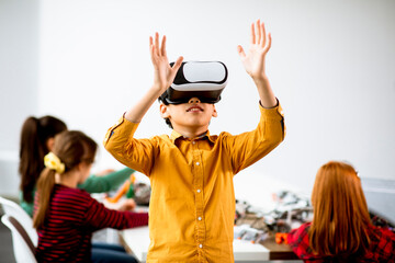 cute little boy wearing vr virtual reality glasses