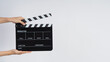© nisara - Hands is holding black Clapper board or Clapperboard or movie slate. it use in video production ,film, cinema industry on white background.