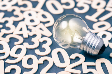 Wall Mural - Glowing Bulb on Wooden Numbers