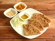 Aloo Paratha Or Indian Potato Stuffed Flatbread. Served With Fresh Curd, Veg Gravy And Salad. Isolated Over A Rustic Wooden Background, Selective Focus