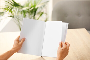 Canvas Print - Old man with blank magazine at home