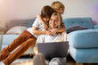 © pikselstock - Young mother trying to work from home with her kids as a company