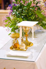 Wall Mural - chalice for wine, blood of christ, and ciborium with host, body of christ, and ampoules with wine and water for consecration