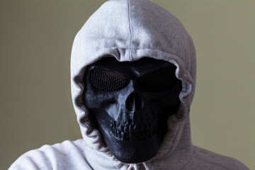 man in black skull mask and white hood. hacker concept. anonymous.