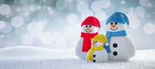 Happy Cute Snowmen Family Standing In Winter Landscape - Greeting Card With Copy Space - 3D Illustration