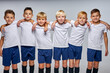 © Roman - soccer team of successful members in sportive uniform looking at camera. caucasian kids enjoy sportive games, posing