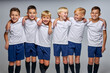 © Roman - soccer team, kids in uniform posing at camera. friendly and strong gathered before match. studio portrait