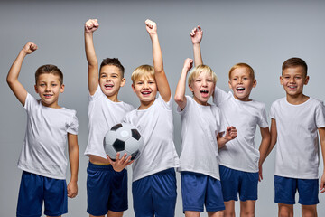 Wall Mural - soccer players boys celebrating the win or victory, raising hands up, smiling, after match. isolated