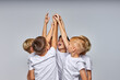 © Roman - team of little soccer players boys raising hands beginning the game, hope to win