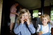© Sam Edwards/Caia Image - Portrait cute sisters eating biscuits in cabin