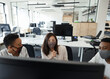 © Paul Bradbury/Caia Image - Business people in face masks working at computer in open plan office