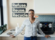 © Paul Bradbury/Caia Image - Portrait confident businesswoman at recycling bins in office kitchen
