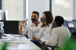 © Paul Bradbury/Caia Image - Business people in face masks working at computer in office