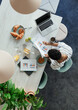 © Paul Bradbury/Caia Image - Businesswoman reviewing paperwork at breakfast in office