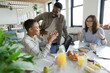 © Paul Bradbury/Caia Image - Business people talking over breakfast in office meeting
