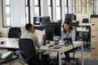 © Paul Bradbury/Caia Image - Businesswomen working at computers in open plan office