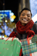 Portrait Happy Young Woman With Christmas Shopping Bags
