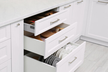 Wall Mural - Open drawers with cutlery and utensils indoors. Order in kitchen