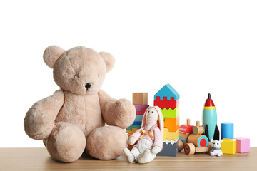 Poster - Set of different toys on wooden table against white background