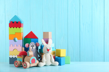 Wall Mural - Set of different toys on light blue wooden table. Space for text