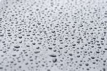 Beads Of Rain Formed On The Hood Of A Car