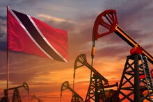 Trinidad And Tobago Oil Industry Concept. Industrial Illustration - Trinidad And Tobago Flag And Oil Wells With The Red And Blue Sunset Or Sunrise Sky Background - 3D Illustration