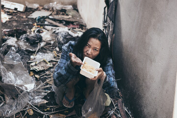 Wall Mural - poor people,homeless or beggar begging for help sitting at dirty slum.concept for poverty hunger,human rights,donate and charity for underprivileged children in third world