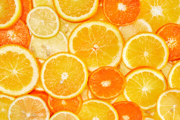 Wall Mural - Colorful creative background of orange, lemon, grapefruit and Mandarin slices. Flat lay macro close-up, top view