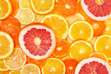 Wall Mural - Colorful creative background of orange, lemon, grapefruit and Mandarin slices. Flat lay macro close-up, top view