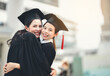 © Fluky - Two students embraced each other and celebrated the joy of graduation.