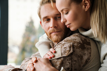 Wall Mural - Beautiful romantic couple hugging and holding hands together at home