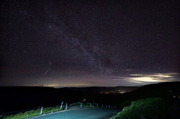 milky way over hawes in the yorkshire dales national park, uk. meteor from ursid meteor shower visib